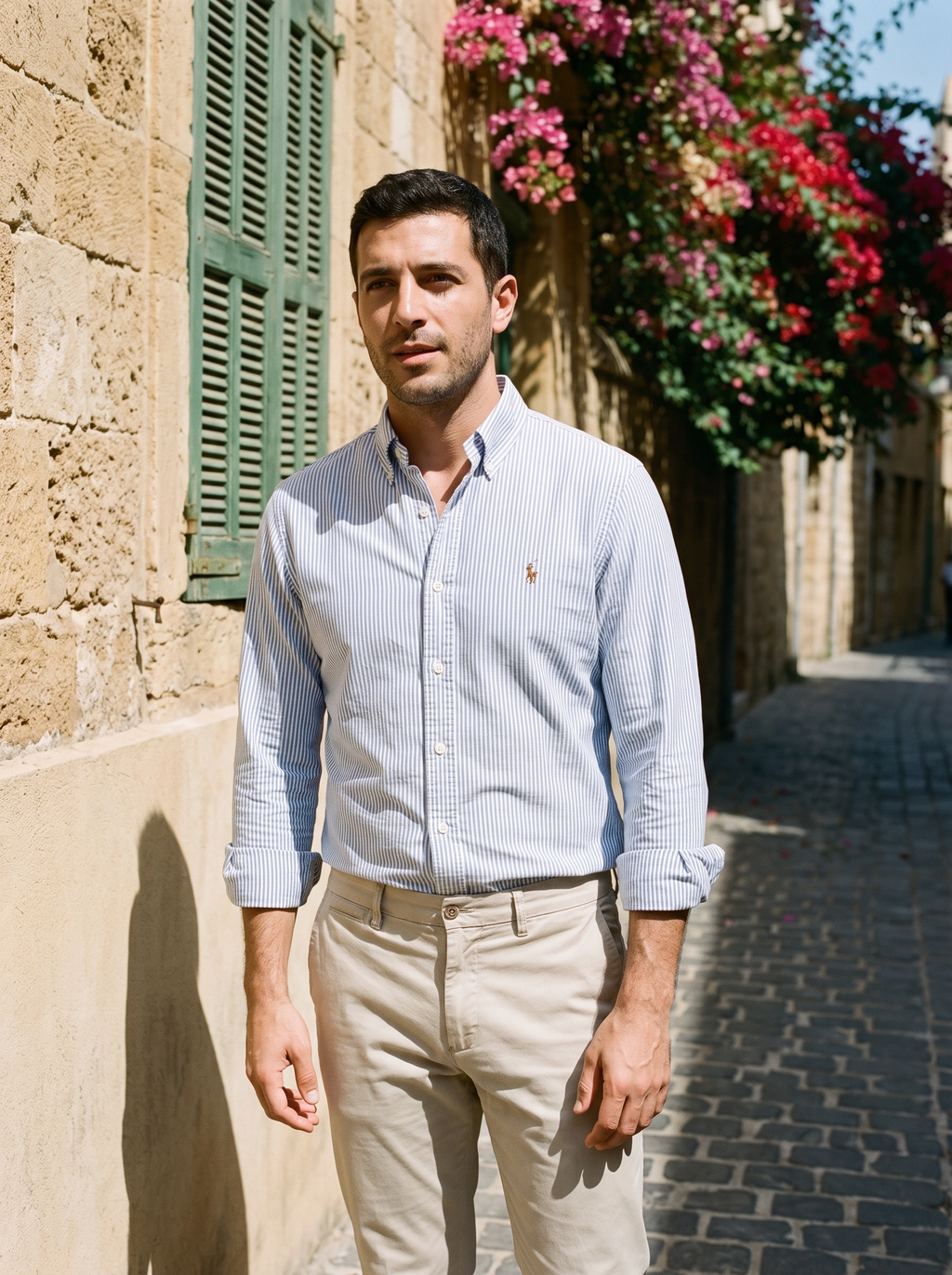 Man in a blue striped Oxford shirt in an old Beirut street